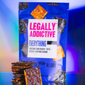 Snack package on blue-purple background labeled 'LEGALLY ADDICTIVE', with stacked chocolate bars in foreground