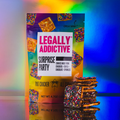 Colorful cereal box labeled LEGALLY ADDICTIVE SURPRISE PARTY, with a bowl of cereal and stacked cereal bars on a rainbow background.